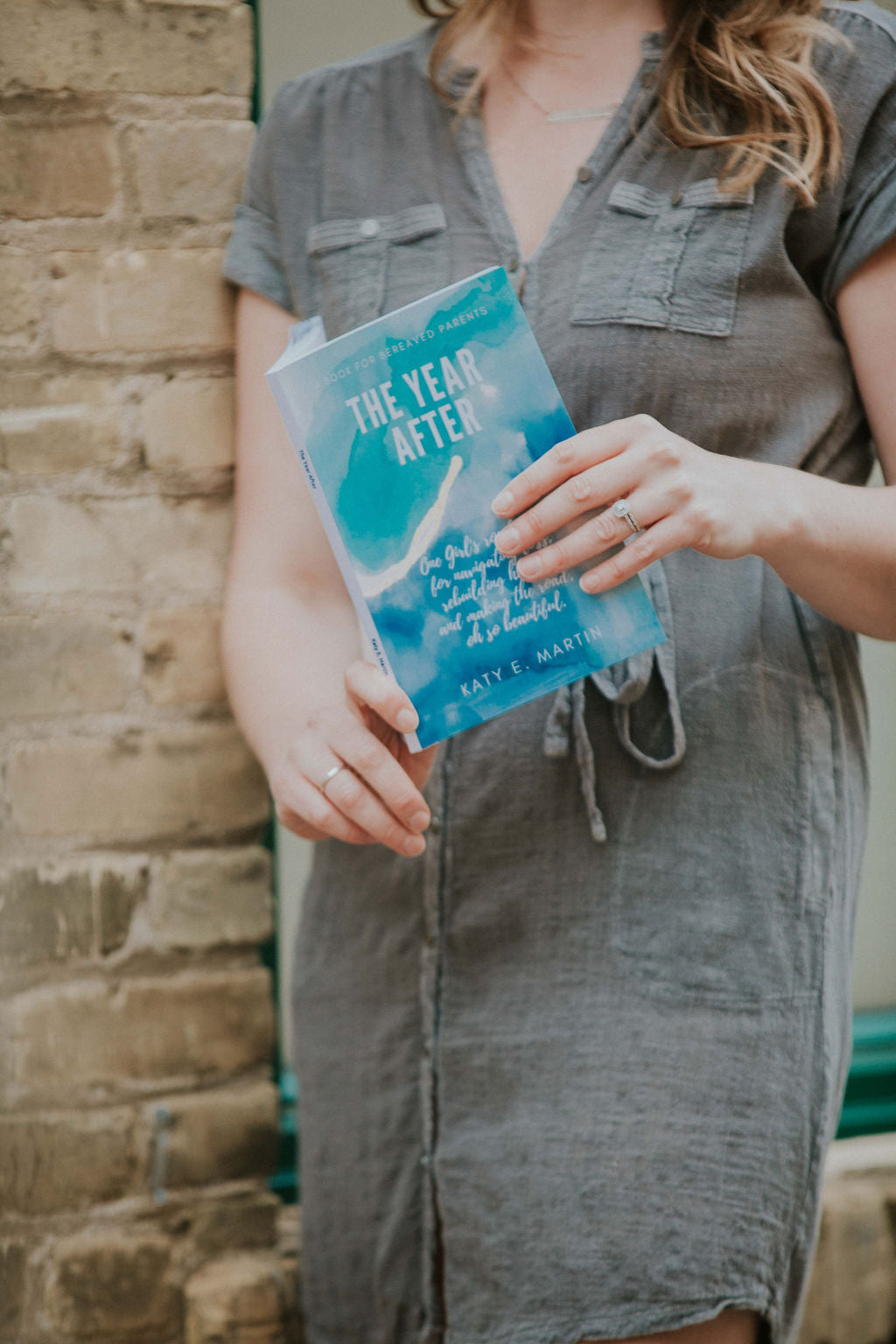 Photo of Author Katy Martin holding her book 'The Year After'