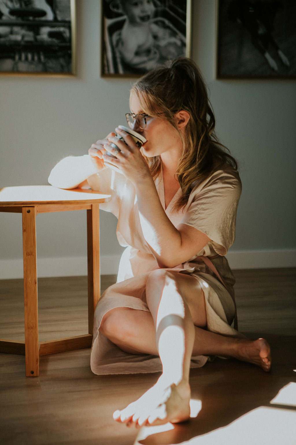 photo of Katy Martin sipping hot tea, sitting on the floor with her legs crossed, deep in thought.