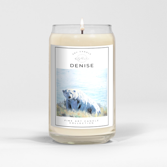 close up of burning white wax candle in a clear glass vessel with fine art polar bear painting by Manitoba Artist Katy Martin on label
