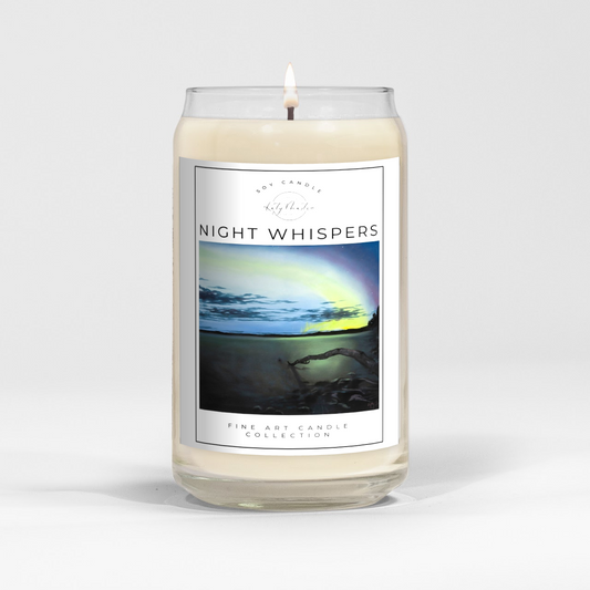 close up of burning white wax candle in a clear glass vessel with fine art landscape painting of the northern lights by Manitoba Artist Katy Martin on label