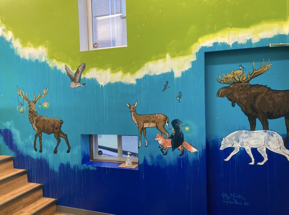 Colorful interior mural of woodland creatures painted on the walls of the toystore hid'n hollow in Neepawa MB.