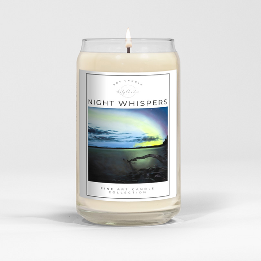 close up of burning white wax candle in a clear glass vessel with fine art landscape painting of the northern lights by Manitoba Artist Katy Martin on label 